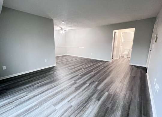 A room with a wooden floor and white walls.