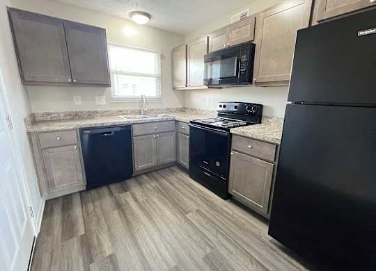 a kitchen with wood flooring and stainless steel appliances at Revere Village Apartments, Centerville, 45458