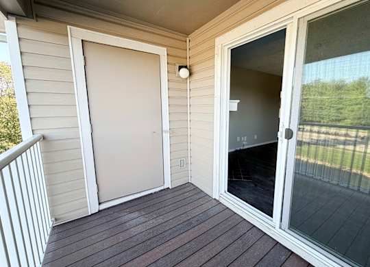 A screened door on a porch with a white frame.