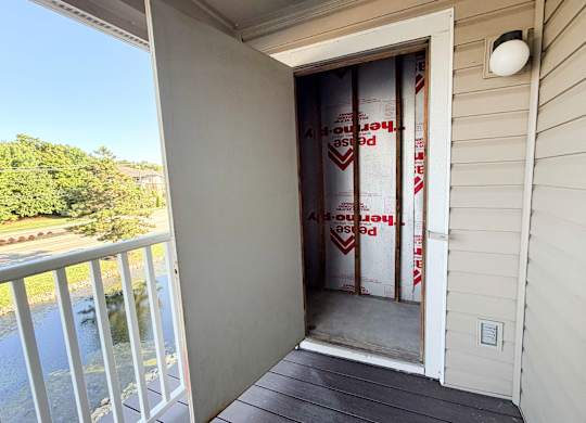 A house under construction with a sign on the door.