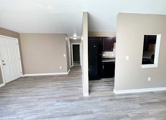 A room with a white door and a black cabinet.