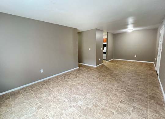 A room with a tiled floor and grey walls.