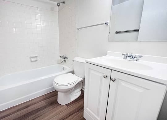 A white toilet sits next to a white sink in a bathroom.