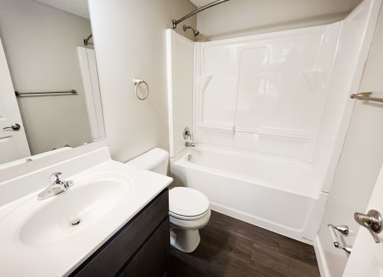 a bathroom with a sink toilet and a tub at Woodhills Apartments, Ohio