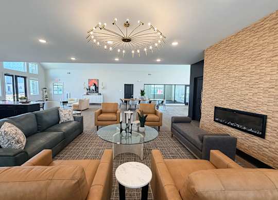 A modern living room with a fireplace and a chandelier.