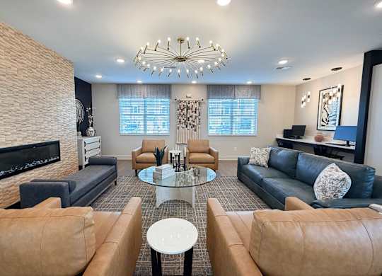 A modern living room with a fireplace and a glass coffee table.