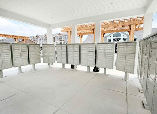 Covered mailbox area with multiple parcel lockers at The Meridian on 32 Apartments, Batavia