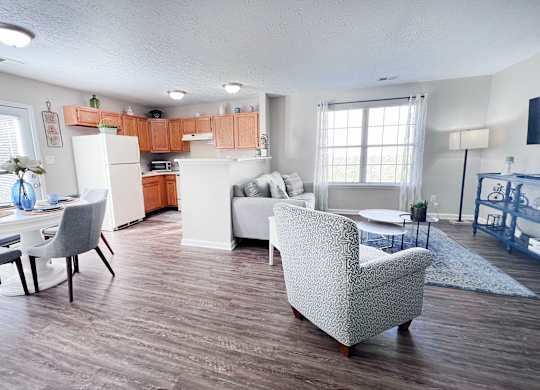 A kitchen with a dining table and chairs.