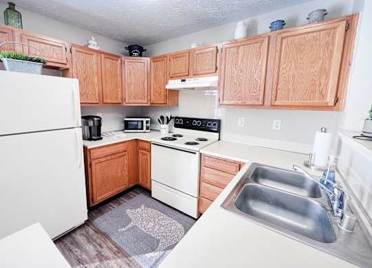 A kitchen with wooden cabinets and a white refrigerator.