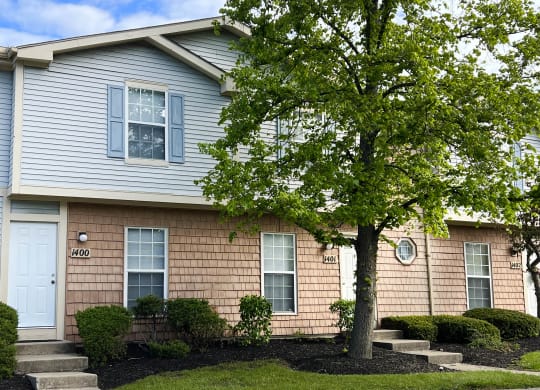a house with a tree in front of it  at Woodhills Apartments, West Carrollton