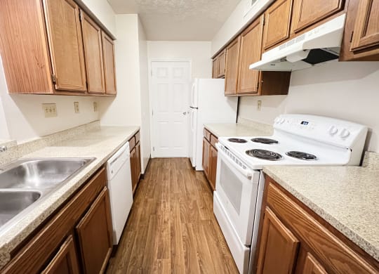 an empty kitchen with wood flooring and white appliances  at Deercross Apartments, Ohio, 45236