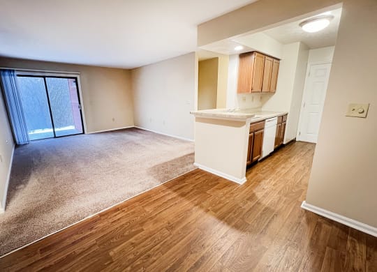 an empty living room and kitchen with a sliding glass door  at Deercross Apartments, Cincinnati, OH, 45236