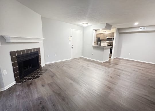 a living room with a fireplace and wooden floors  at Deercross Apartments, Ohio, 45236
