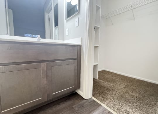 a bathroom with a vanity with a mirror and a sink  at Deercross Apartments, Cincinnati