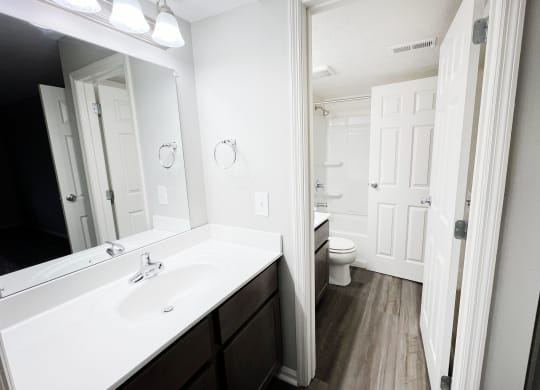 a bathroom with a sink and a mirror  at Deercross Apartments, Ohio, 45236