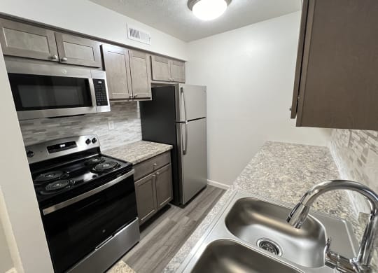 a kitchen with stainless steel appliances and granite counter tops  at Deercross Apartments, Ohio, 45236