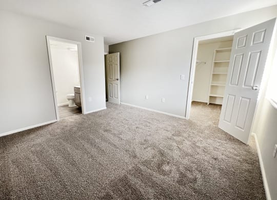 an empty living room with carpet and a closet  at Deercross Apartments, Cincinnati, 45236