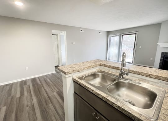 an empty kitchen with a sink and a window  at Deercross Apartments, Cincinnati, OH, 45236