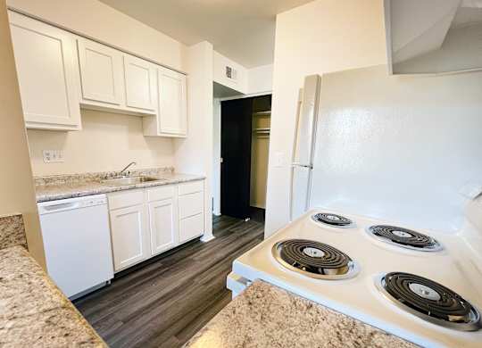 an empty kitchen with white appliances and a white refrigerator at Four Worlds Apartments, Cincinnati, OH