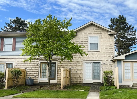 a house with a tree in front of it  at Woodhills Apartments, West Carrollton, OH, 45449