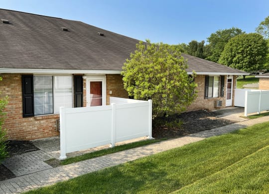 a house with a white fence in front of it  at Wyndemere Apartments, Ohio, 45005