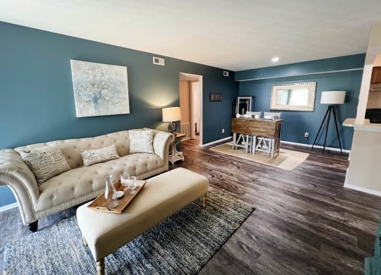 a living room with a couch and a coffee table  at Steeplechase Apartments, Loveland
