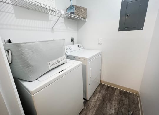 a small laundry room with a washer and dryer  at Steeplechase Apartments, Loveland, 45140