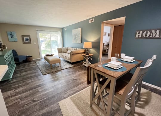 an open concept living room with a dining room table and chairs  at Steeplechase Apartments, Loveland, Ohio