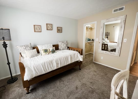 a bedroom with a bed and a lamp  at Steeplechase Apartments, Loveland