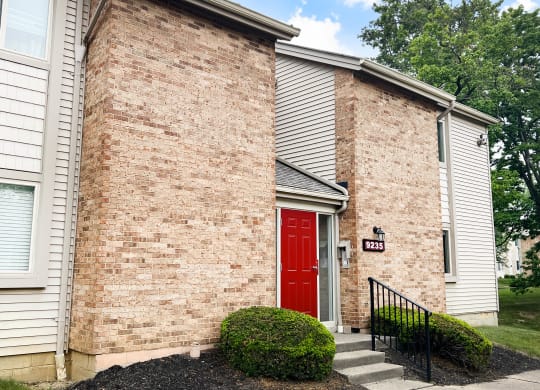a red door on a brick building  at Hunter's Creek Apartments, Ohio, 45242