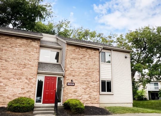 a red door on a brick building  at Hunter's Creek Apartments, Ohio, 45242