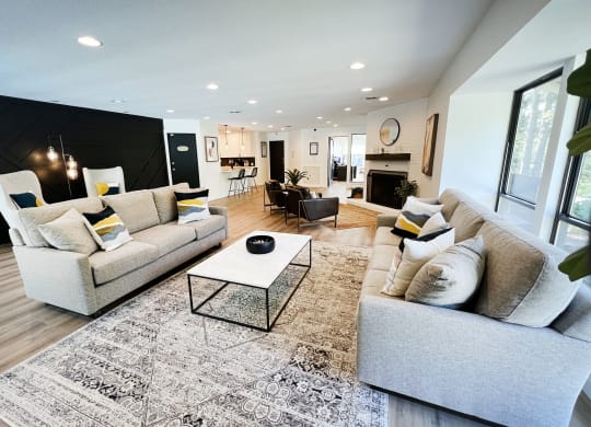 a living room with couches and a coffee table in front of a fireplace at Indian Lookout Apartments, Cincinnati, OH, 45238