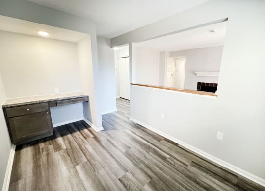 an empty room with a desk and a mirror in a new home  at Deercross Apartments, Ohio