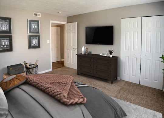 a bedroom with a bed and a dresser with a television  at Knobs Pointe Apartments, New Albany, Indiana