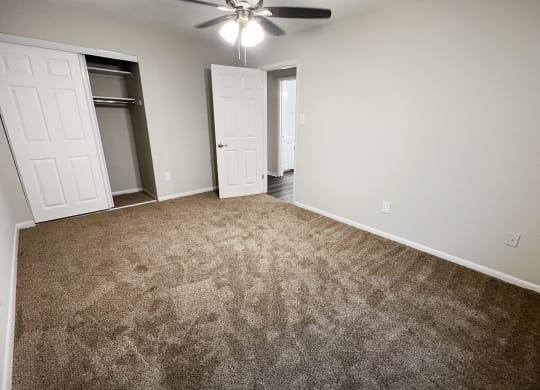 an empty living room with carpet and a ceiling fan at Crown Court Apartments, Kentucky, 41042