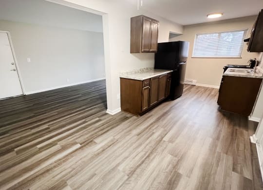 an empty kitchen and living room with wood flooring at Crown Court Apartments, Kentucky, 41042
