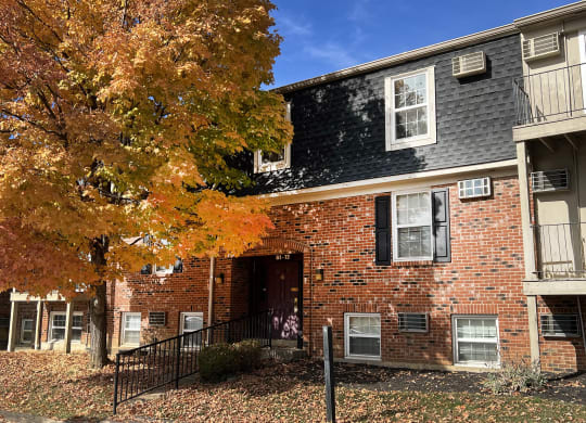 a brick building with a tree in front of it at Concord Woods Apartments, Milford, Ohio 45150
