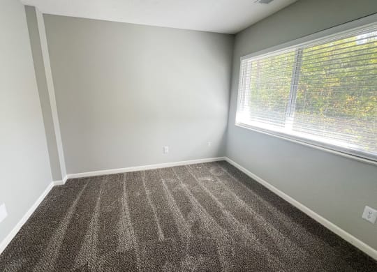 an empty room with carpet and a large window at Fox Run Apartments, Cincinnati, OH, 45236