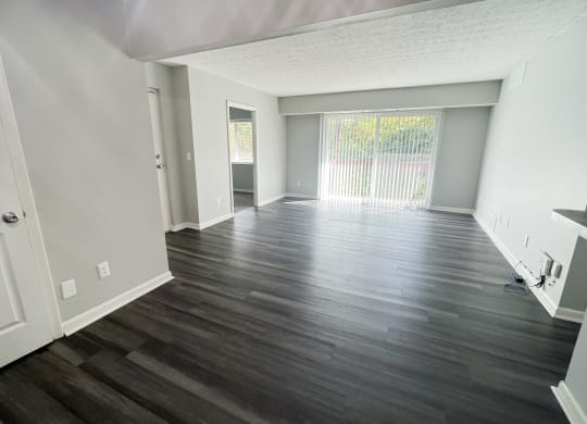 an empty living room with wood flooring and a window at Fox Run Apartments, OH, 45236