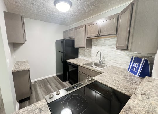 a kitchen with a stove and a sink and a refrigerator at Fox Run Apartments, Cincinnati, Ohio, 45236