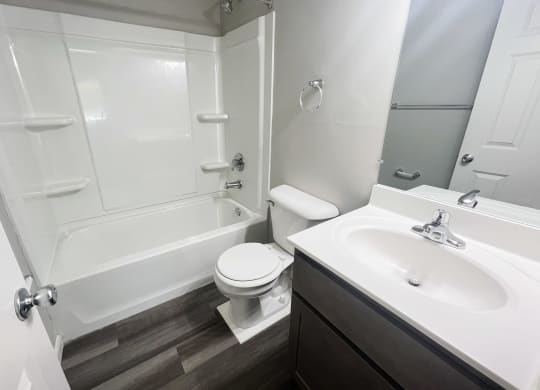 an empty bathroom with a sink toilet and shower at Fox Run Apartments, Cincinnati, Ohio