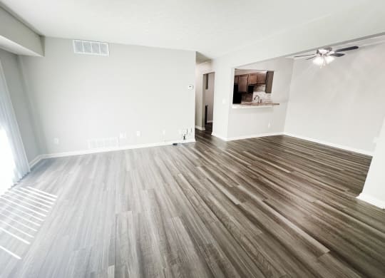 an empty living room with wood flooring in a new home at Fox Run Apartments, Cincinnati, OH
