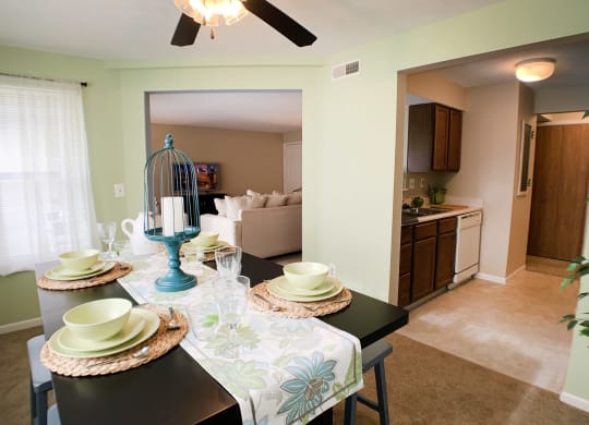 a dining room and living room with a table and chairs at The Vinings Apartments, Cincinnati, 45245