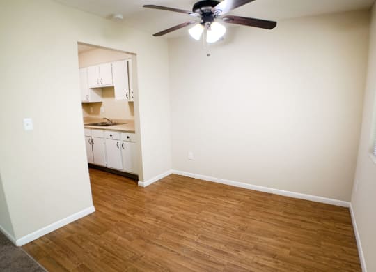 an empty living room with a wooden floor and a ceiling fan  at Hunter's Creek Apartments, Cincinnati, 45242