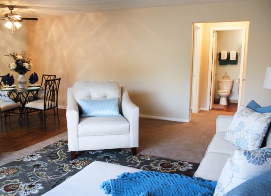 a living room with white furniture and a blue rug  at Hunter's Creek Apartments, Cincinnati, OH