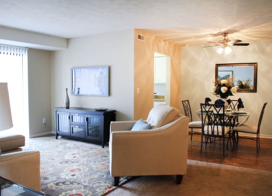 a living room with a couch and a dining room table  at Hunter's Creek Apartments, Cincinnati, 45242
