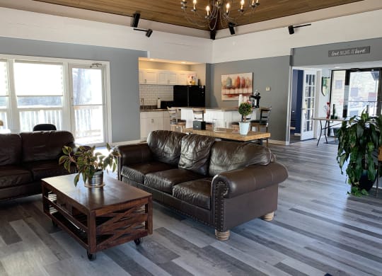 a living room with leather couches and a coffee table at Timber Ridge Apartments, Cincinnati