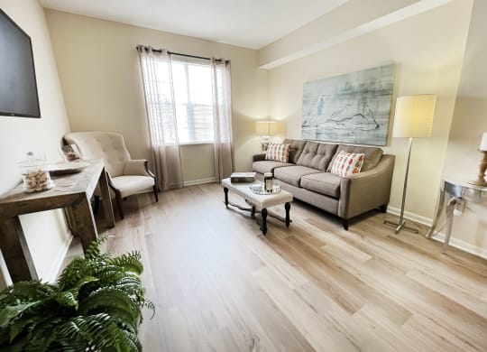 a living room with a couch and a table at Residences at Northgate Crossing, Ohio, 43235