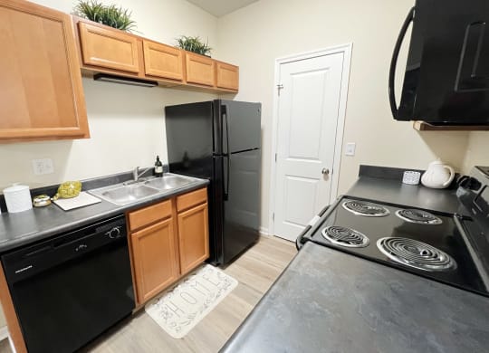 a kitchen with black appliances and a black stove and refrigerator at Residences at Northgate Crossing, Ohio, 43235