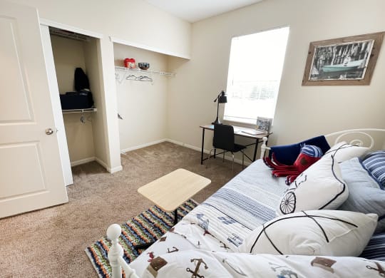 a living room with a bed and a closet at Residences at Northgate Crossing, Ohio, 43235